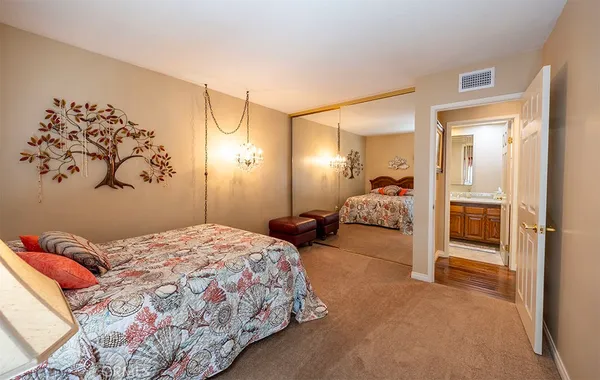 a bedroom with a bed and a painting on the wall