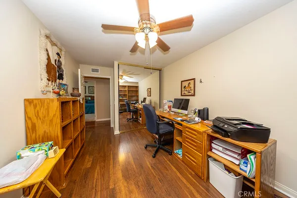 a work room with furniture and wooden floor