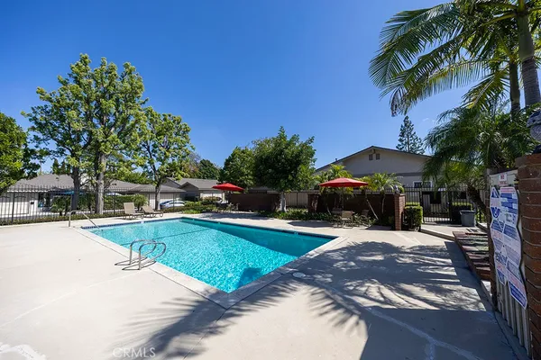 a view of a swimming pool with a patio and a garden