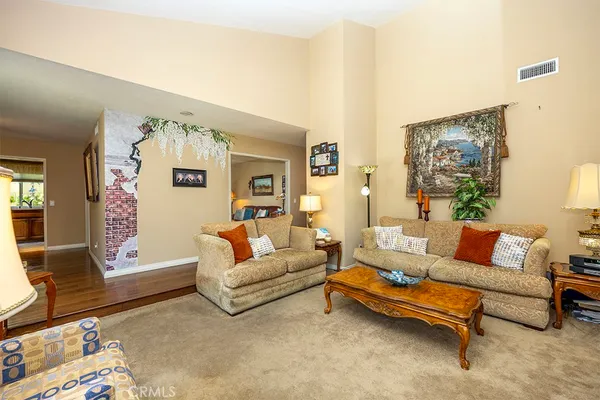 a living room with furniture and painting on the wall