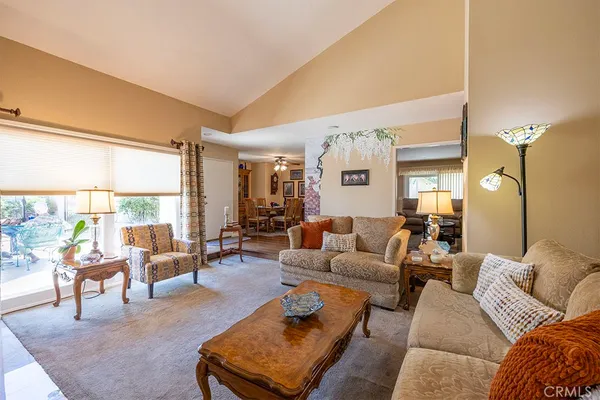 a living room with furniture and large windows