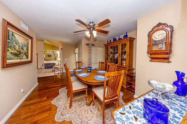 a dining room with furniture and wooden floor