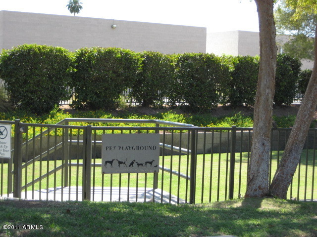 4488 East Thomas Road, Unit 1044 Phoenix, AZ 85018 - Photo 13 of 31 a view of a wooden fence