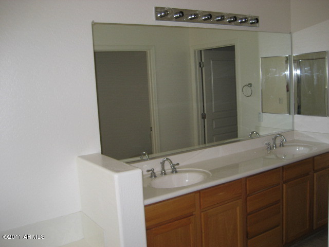 4488 East Thomas Road, Unit 1044 Phoenix, AZ 85018 - Photo 25 of 31 a bathroom with a granite countertop sink and a mirror