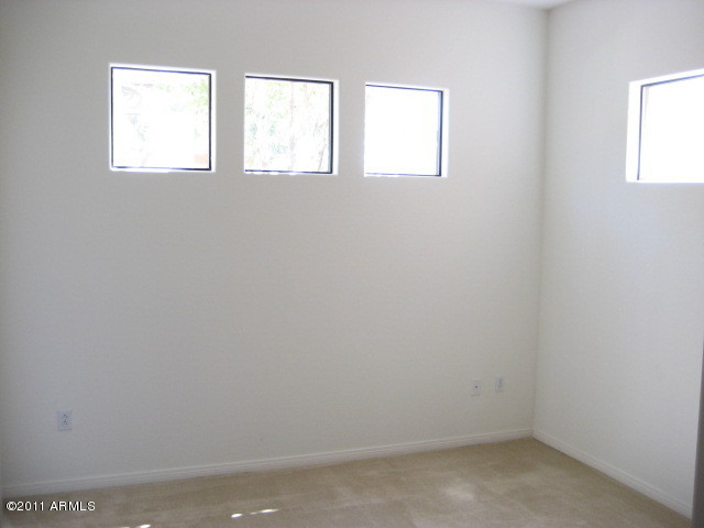 4488 East Thomas Road, Unit 1044 Phoenix, AZ 85018 - Photo 27 of 31 an empty room with windows