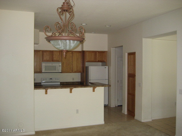 4488 East Thomas Road, Unit 1044 Phoenix, AZ 85018 - Photo 28 of 31 a kitchen with a sink and refrigerator