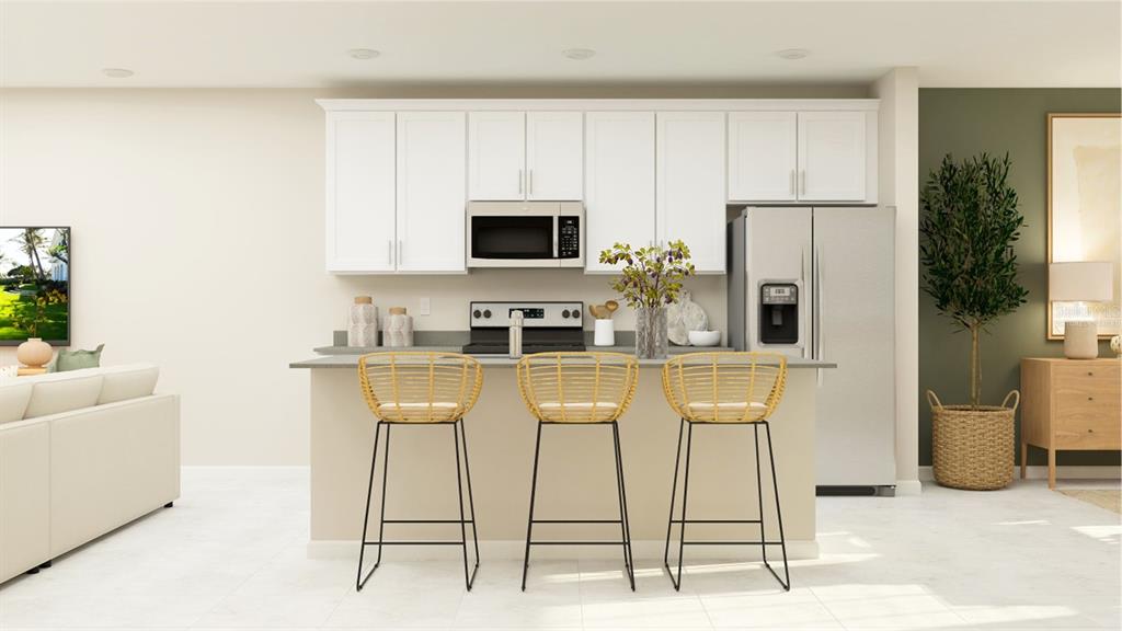 10262 Hadley Street Orlando, FL 32829 - Photo 3 of 19 a kitchen with stainless steel appliances kitchen island granite countertop a refrigerator and microwave