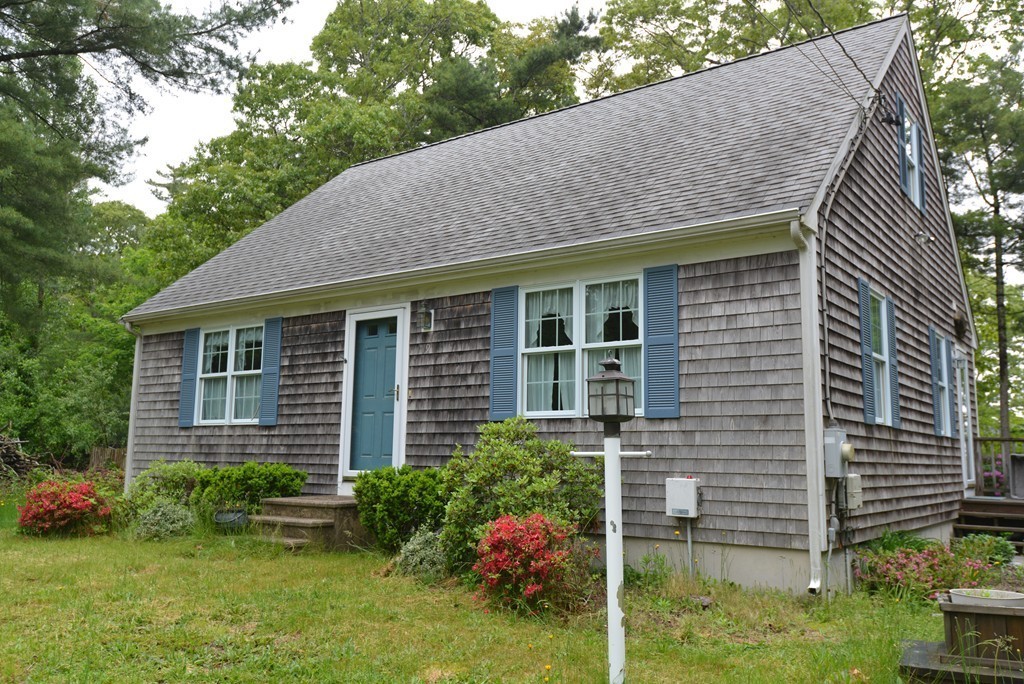 79 Converse Road Marion, MA 02738 - Photo 1 of 13 a front view of a house with garden