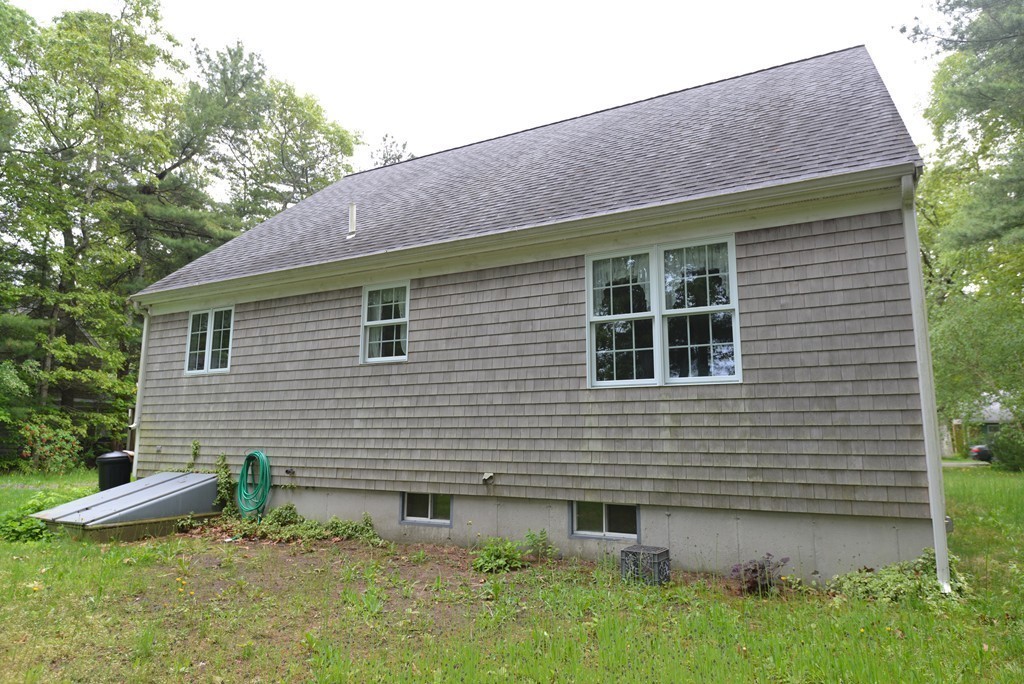 79 Converse Road Marion, MA 02738 - Photo 2 of 13 a view of a backyard with plants and large tree