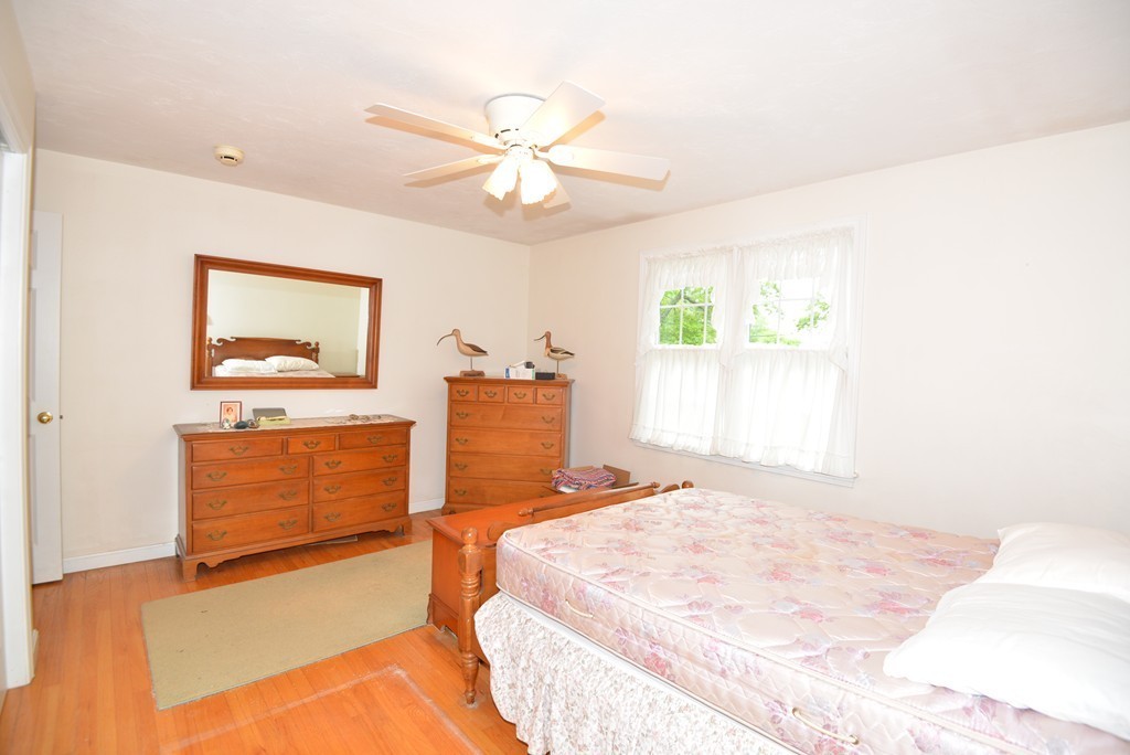 79 Converse Road Marion, MA 02738 - Photo 8 of 13 a bedroom with a bed and a dresser