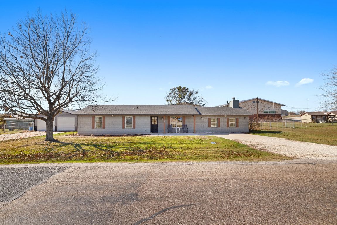 301 North 8th Street Jarrell, TX 76537 - Photo 4 of 27 a view of a house with a big yard and large trees