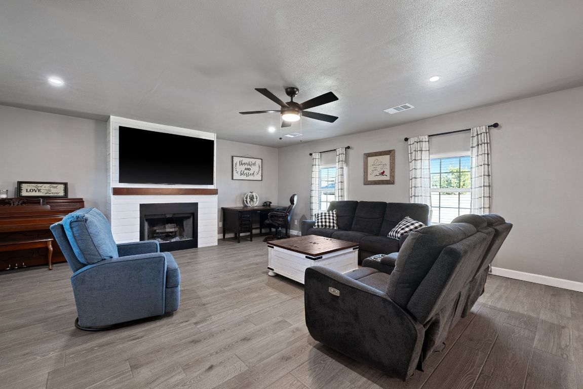 301 North 8th Street Jarrell, TX 76537 - Photo 6 of 27 a living room with furniture a fireplace and a flat screen tv