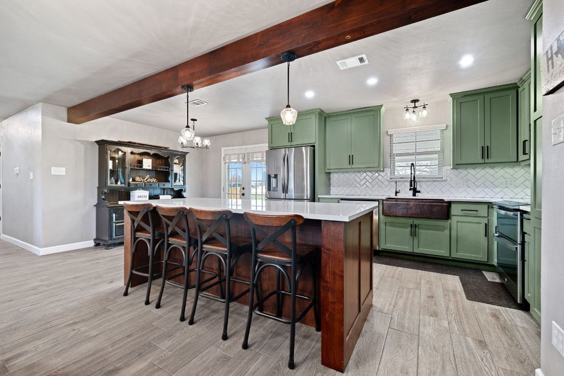 301 North 8th Street Jarrell, TX 76537 - Photo 10 of 27 a kitchen with a sink cabinets and wooden floor