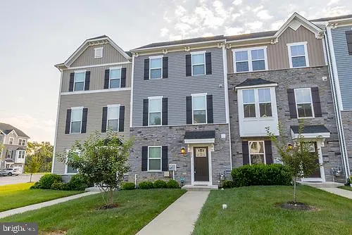 a front view of a brick house with a yard