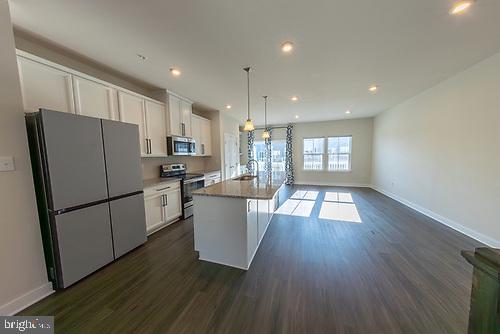 272 Sugar Maple Square Downingtown, PA 19335 - Photo 14 of 41 a kitchen with kitchen island wooden floors white appliances and cabinets