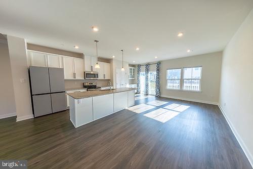 272 Sugar Maple Square Downingtown, PA 19335 - Photo 16 of 41 a kitchen with a refrigerator and white cabinets