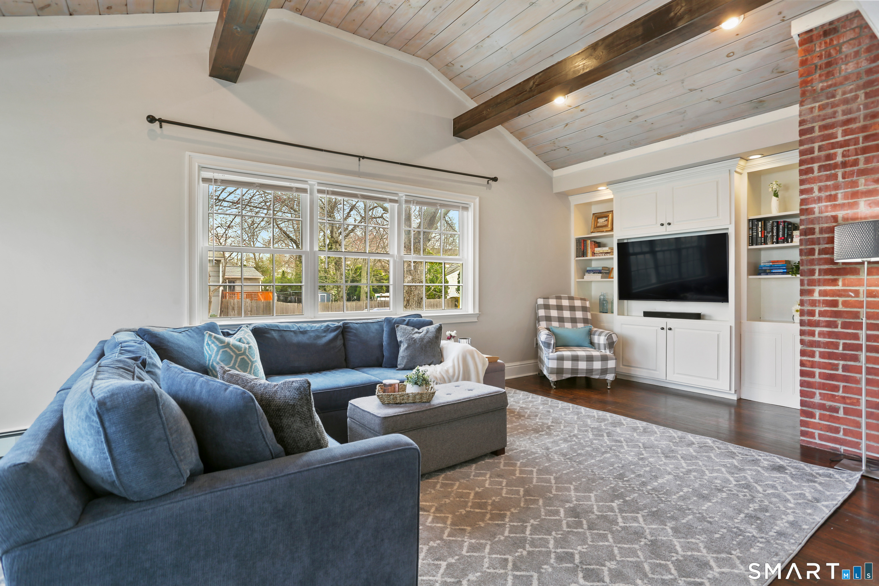185 Windsor Road Fairfield, CT 06824 - Photo 11 of 41 a living room with furniture and a flat screen tv