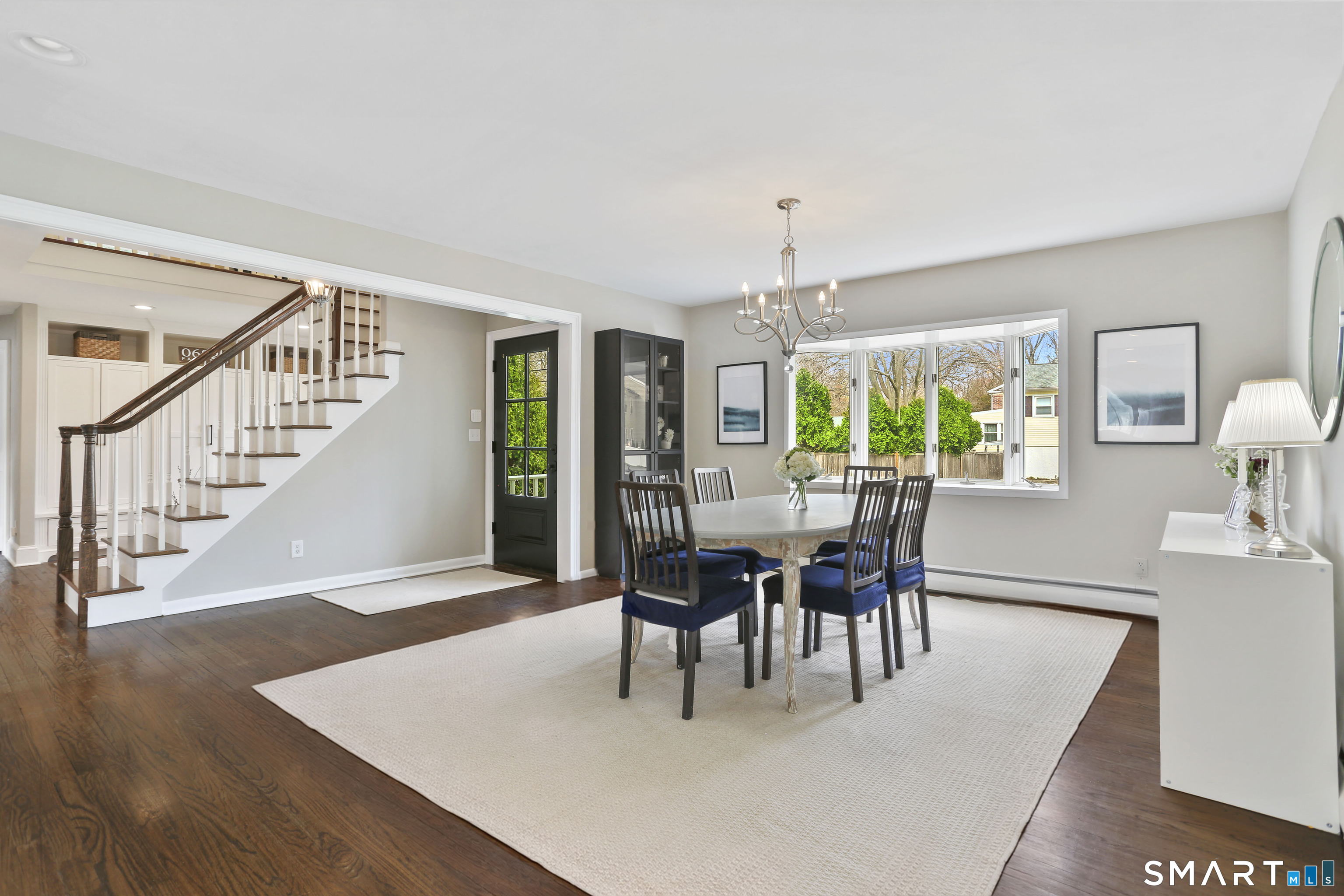 185 Windsor Road Fairfield, CT 06824 - Photo 14 of 41 a view of a dining room with furniture and chandelier