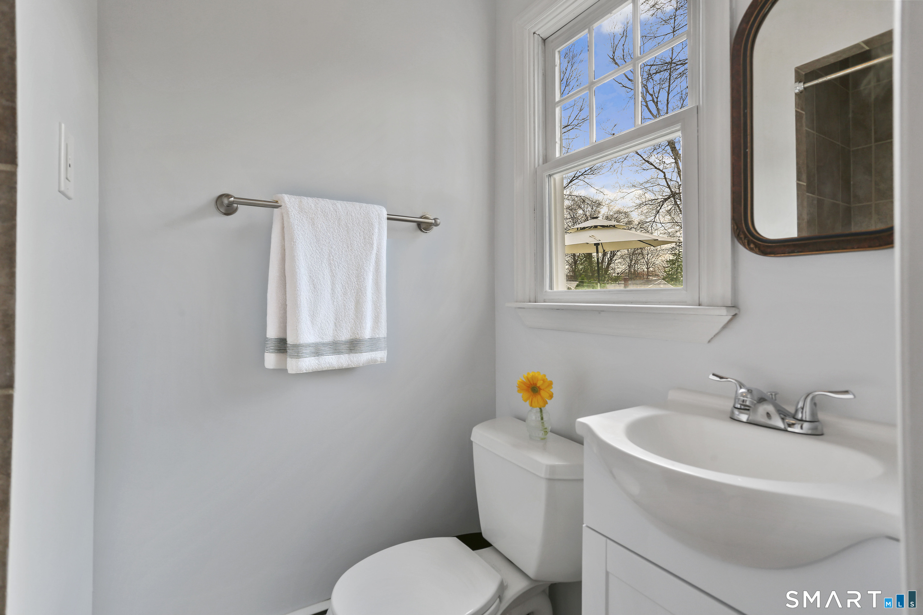 185 Windsor Road Fairfield, CT 06824 - Photo 16 of 41 a white toilet sitting next to a bathroom sink