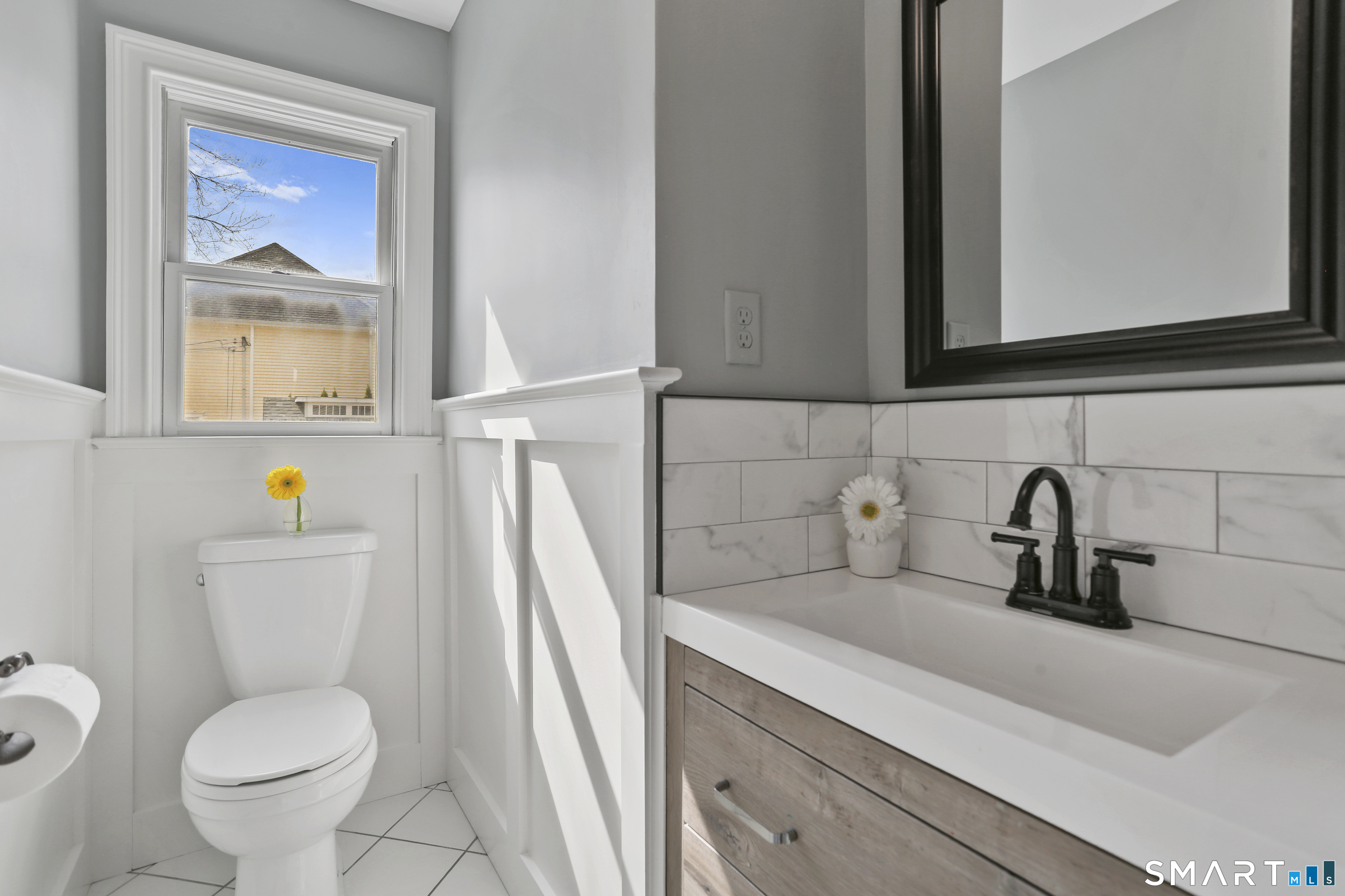 185 Windsor Road Fairfield, CT 06824 - Photo 18 of 41 a bathroom with a toilet sink and mirror