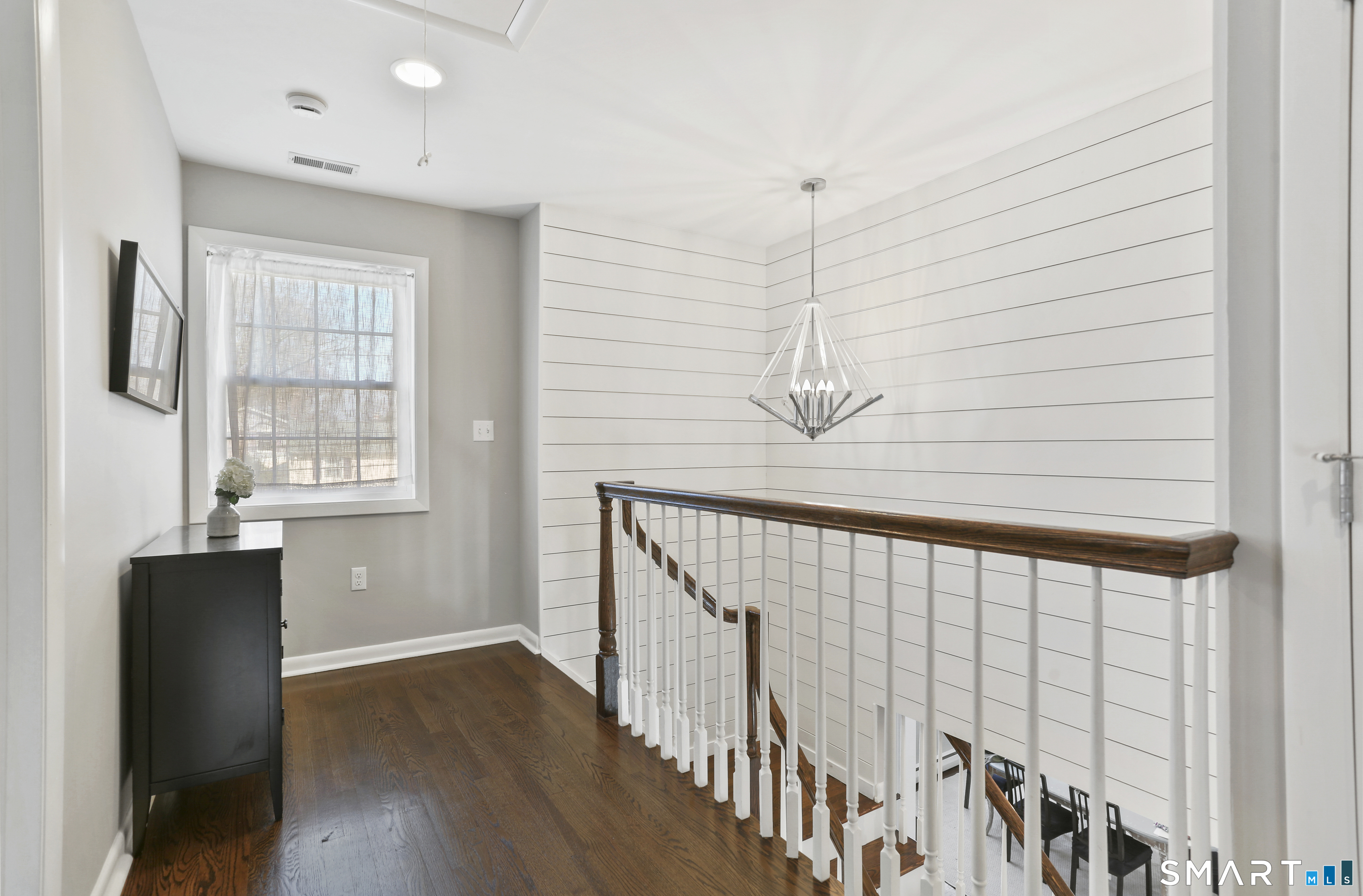 185 Windsor Road Fairfield, CT 06824 - Photo 21 of 41 a view of a hallway with wooden floor and staircase