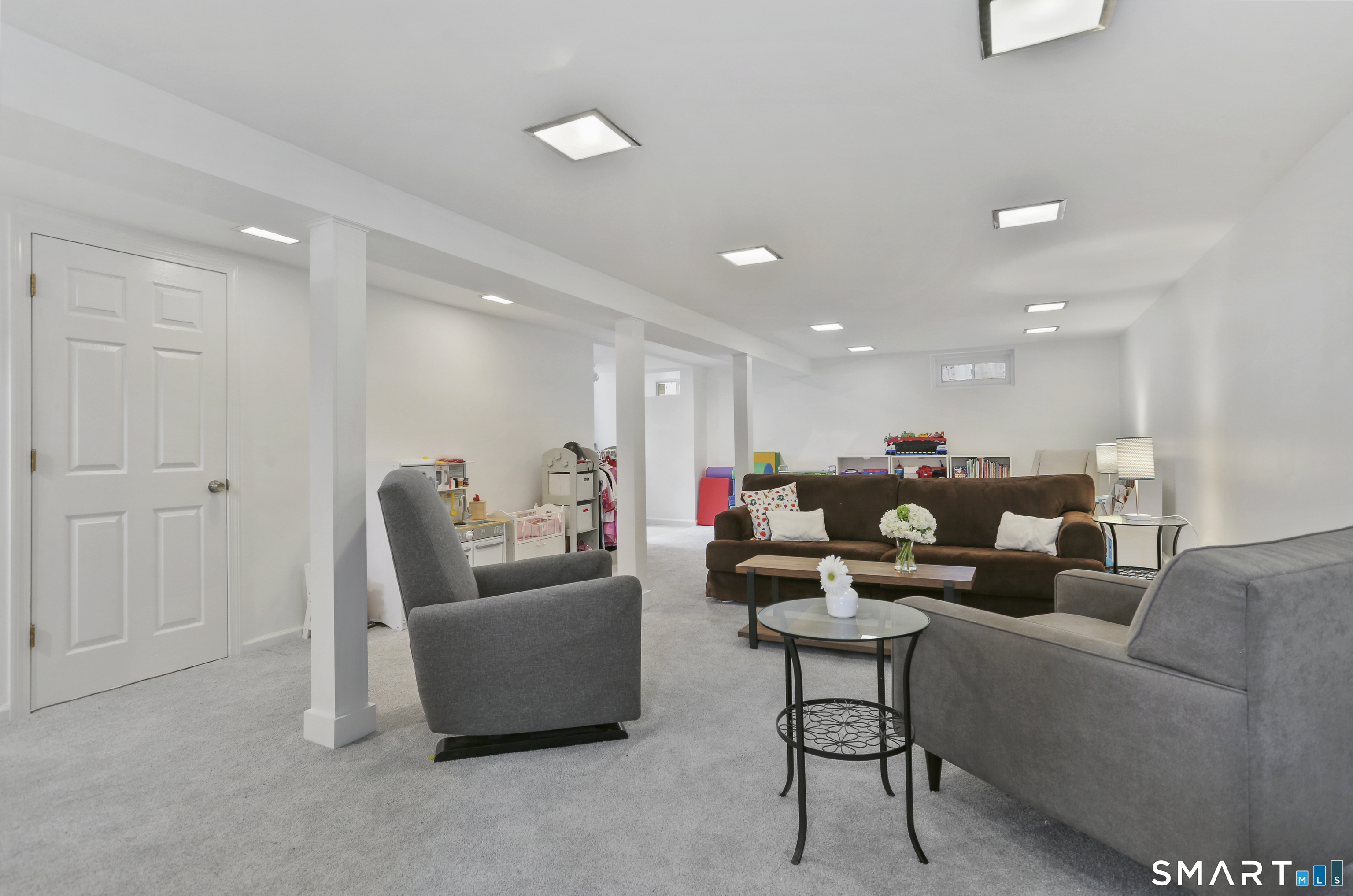 185 Windsor Road Fairfield, CT 06824 - Photo 27 of 41 a living room with furniture and a couch