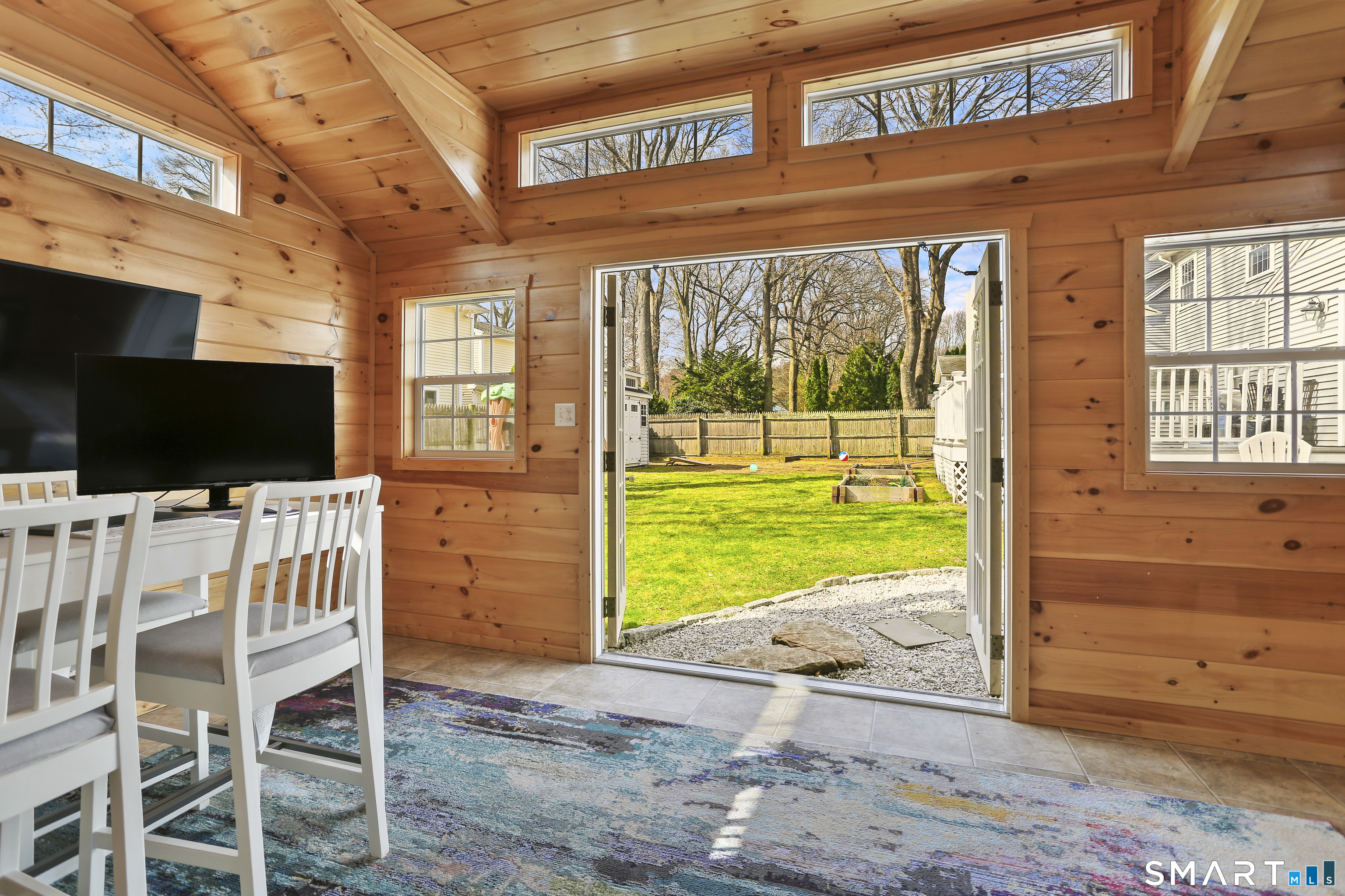 185 Windsor Road Fairfield, CT 06824 - Photo 30 of 41 a view of a patio with a table and chairs