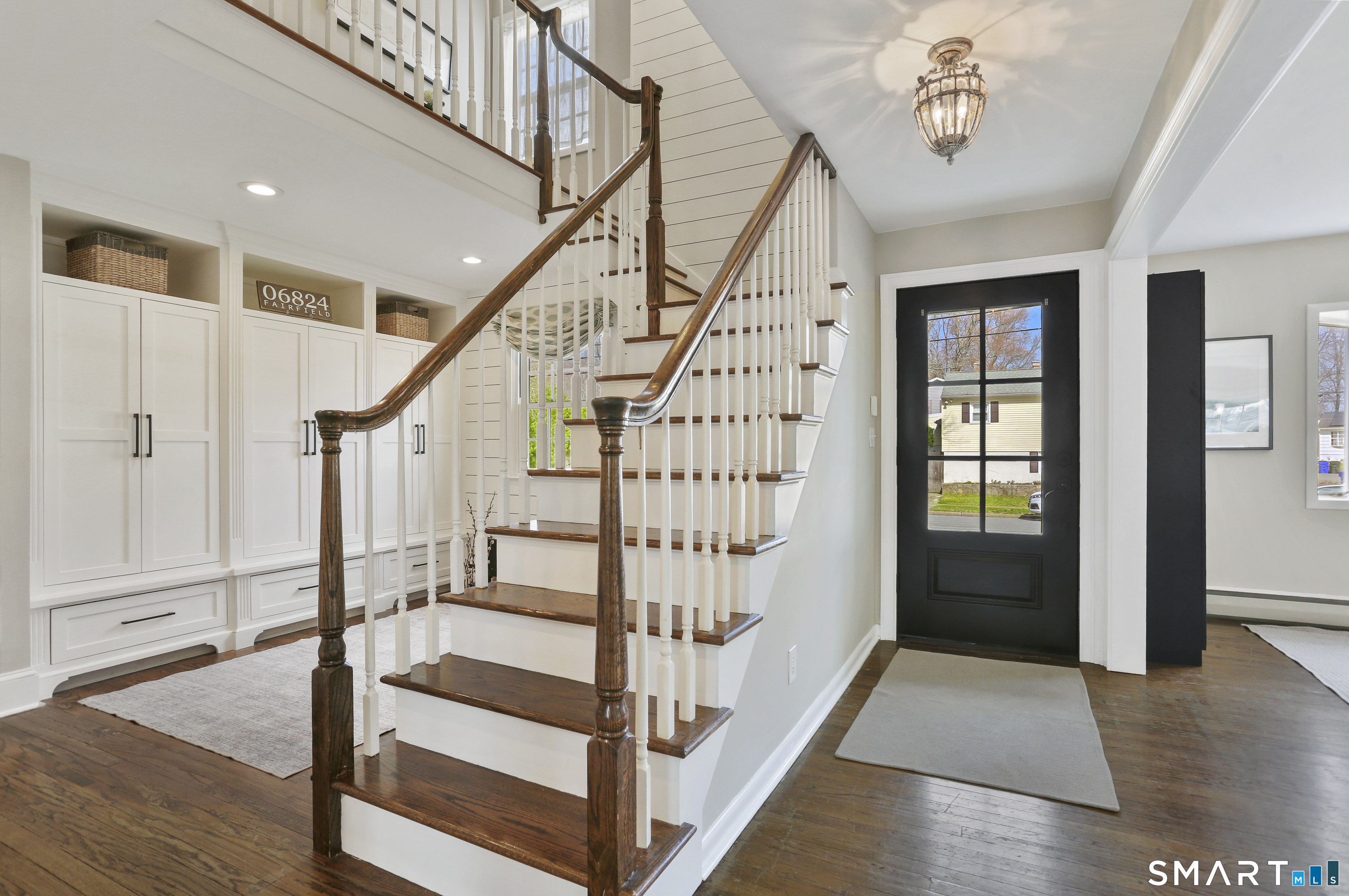 185 Windsor Road Fairfield, CT 06824 - Photo 3 of 41 a view of entryway with wooden floor and stairs
