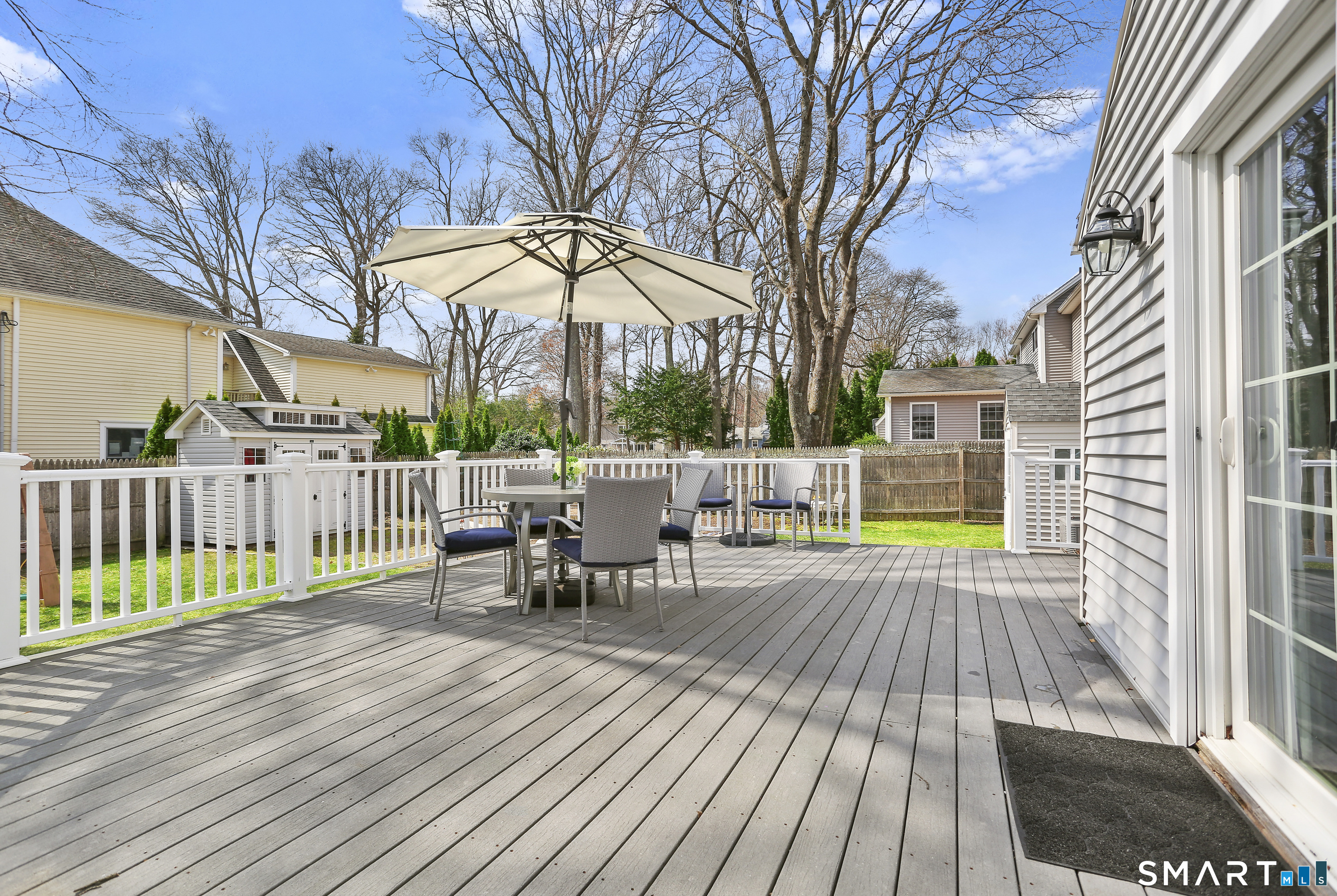 185 Windsor Road Fairfield, CT 06824 - Photo 34 of 41 a view of a roof deck with wooden floor and fence