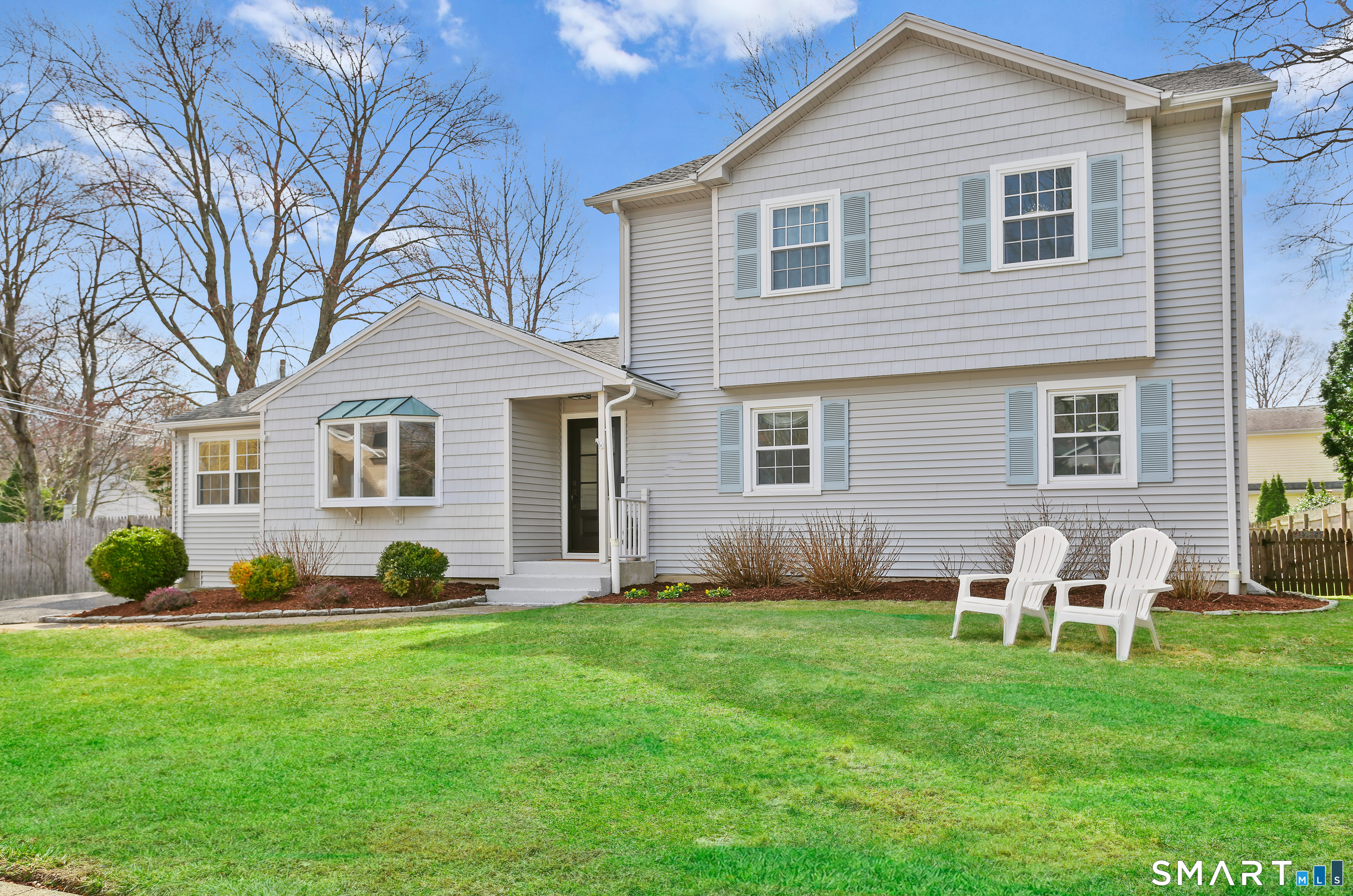 185 Windsor Road Fairfield, CT 06824 - Photo 41 of 41 a front view of a house with a yard and green space