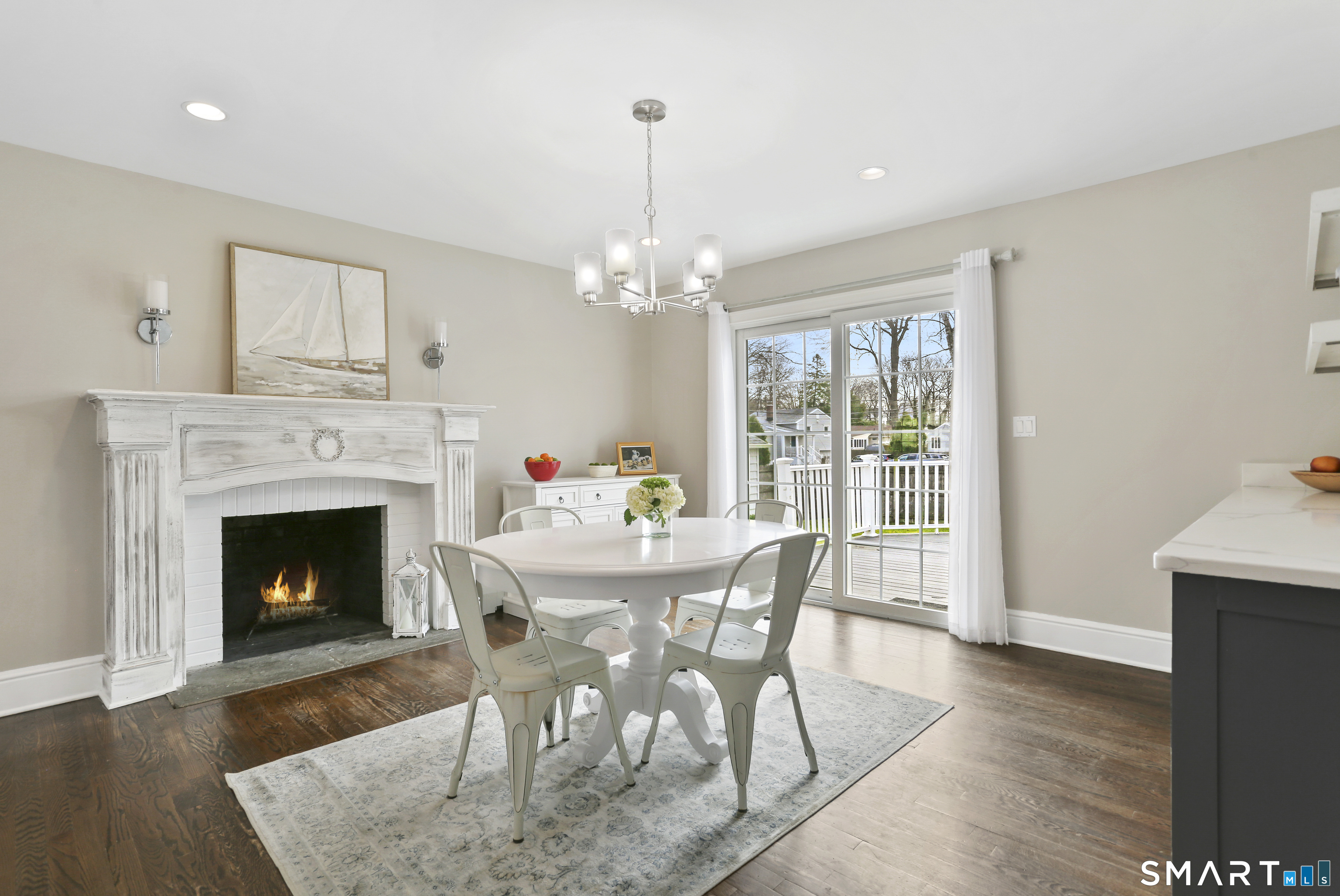 185 Windsor Road Fairfield, CT 06824 - Photo 8 of 41 a dining room with furniture a fireplace and wooden floor