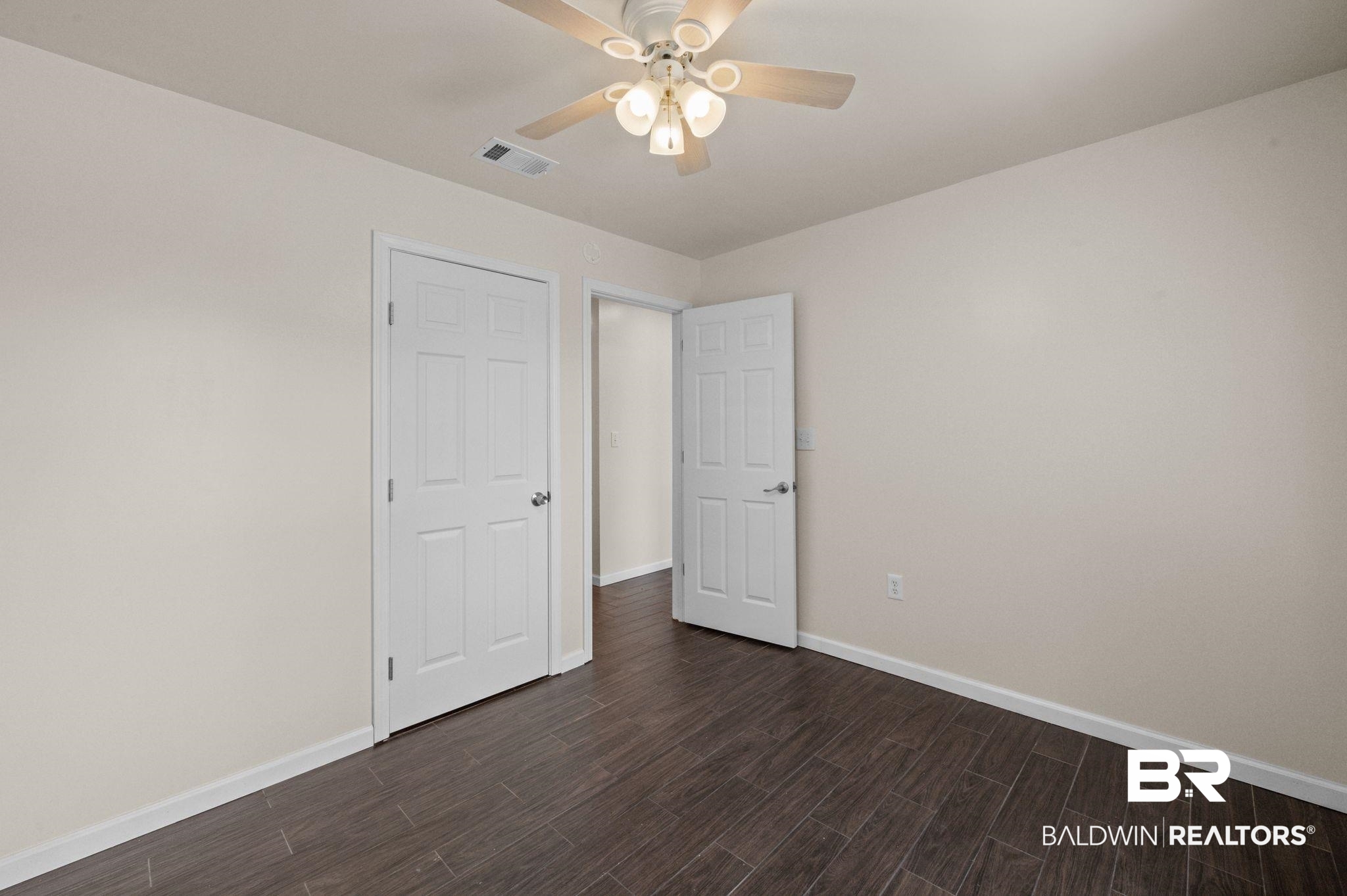 20037 County Road 33 Fairhope, AL 36532 - Photo 56 of 79 Unfurnished bedroom with dark hardwood / wood-style flooring and ceiling fan