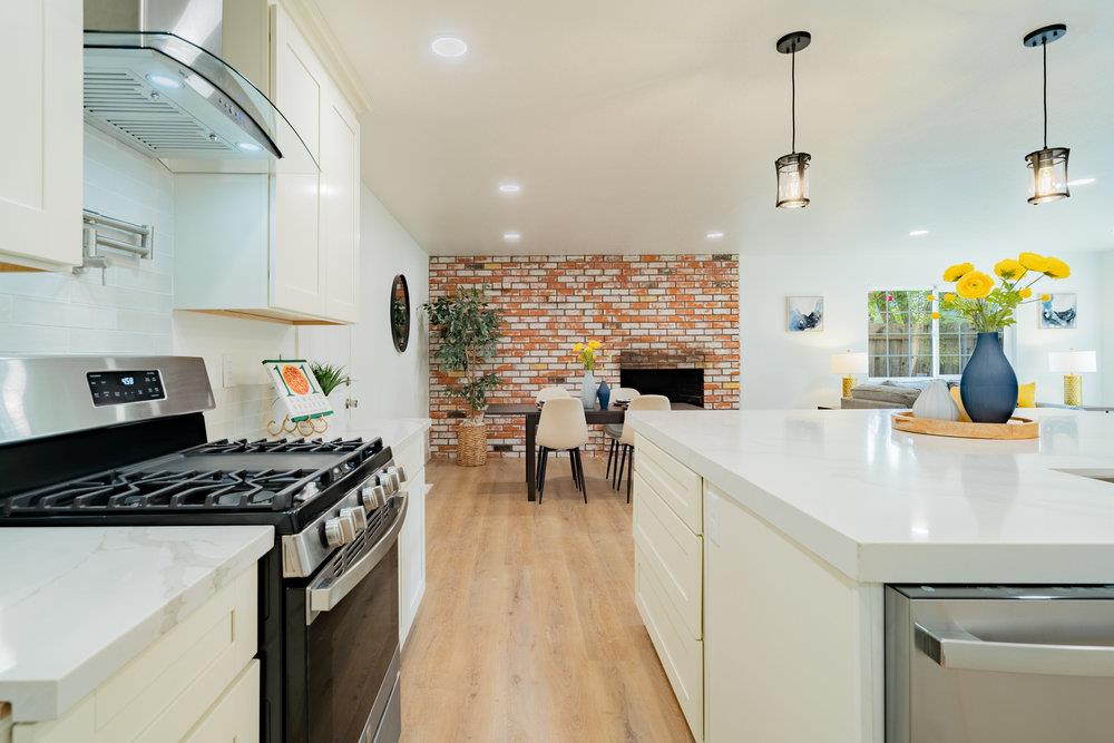 741 West 6th Street Gilroy, CA 95020 - Photo 11 of 29 a kitchen with kitchen island a stove a sink and a refrigerator