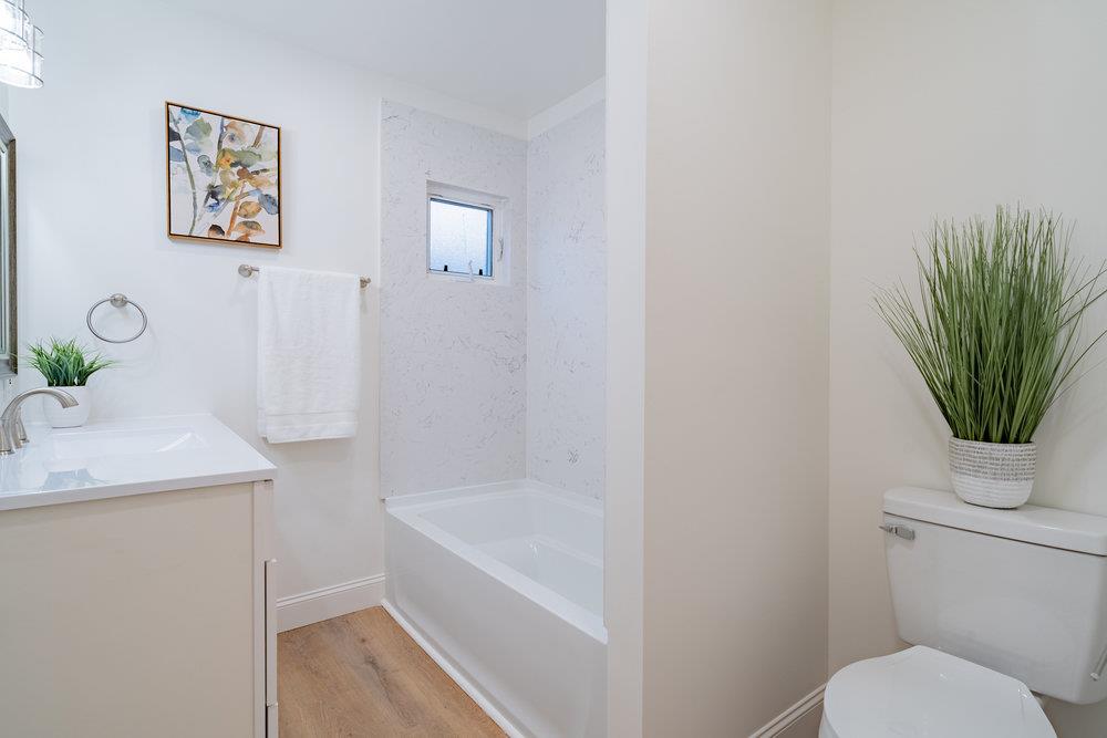 741 West 6th Street Gilroy, CA 95020 - Photo 23 of 29 a bathroom with a granite countertop sink a toilet and bathtub