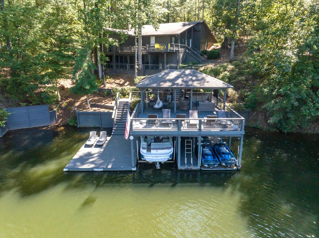 94 Hidden Trail Hamilton, GA 31811 - Photo 1 of 46 an aerial view of a house with swimming pool patio and lake view