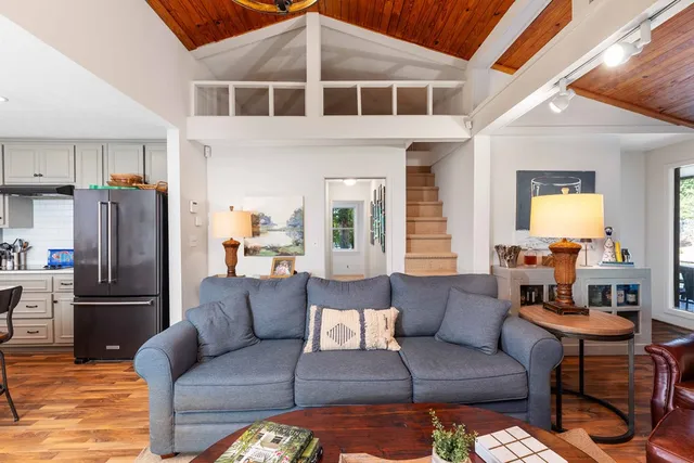 a view of a living room kitchen and a refrigerator