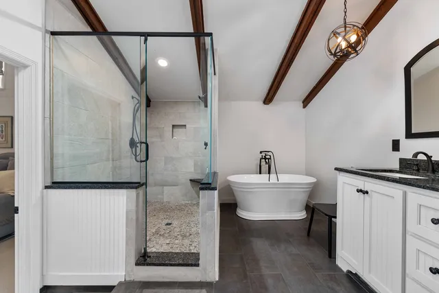 a bathroom with a sink a toilet and a shower