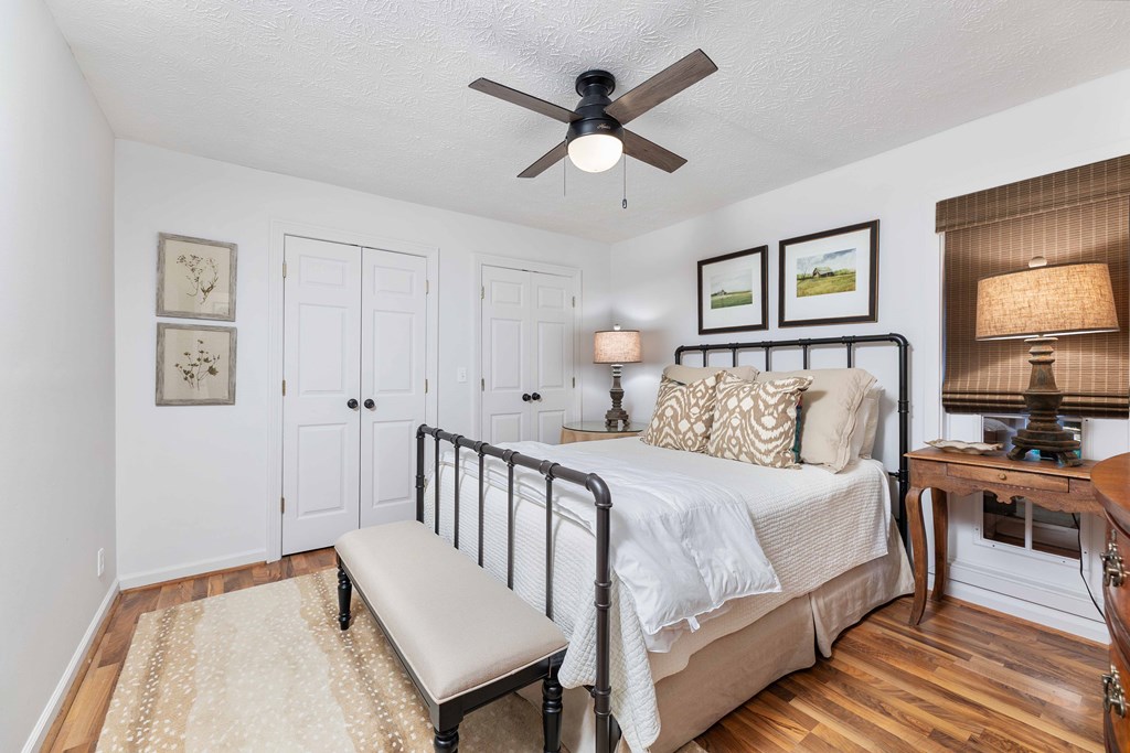 94 Hidden Trail Hamilton, GA 31811 - Photo 20 of 46 a bedroom with a bed and a chandelier