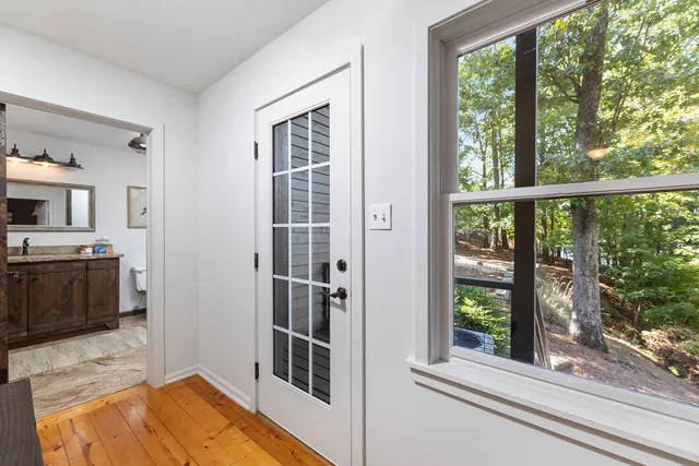 a spacious bathroom with a toilet sink and mirror