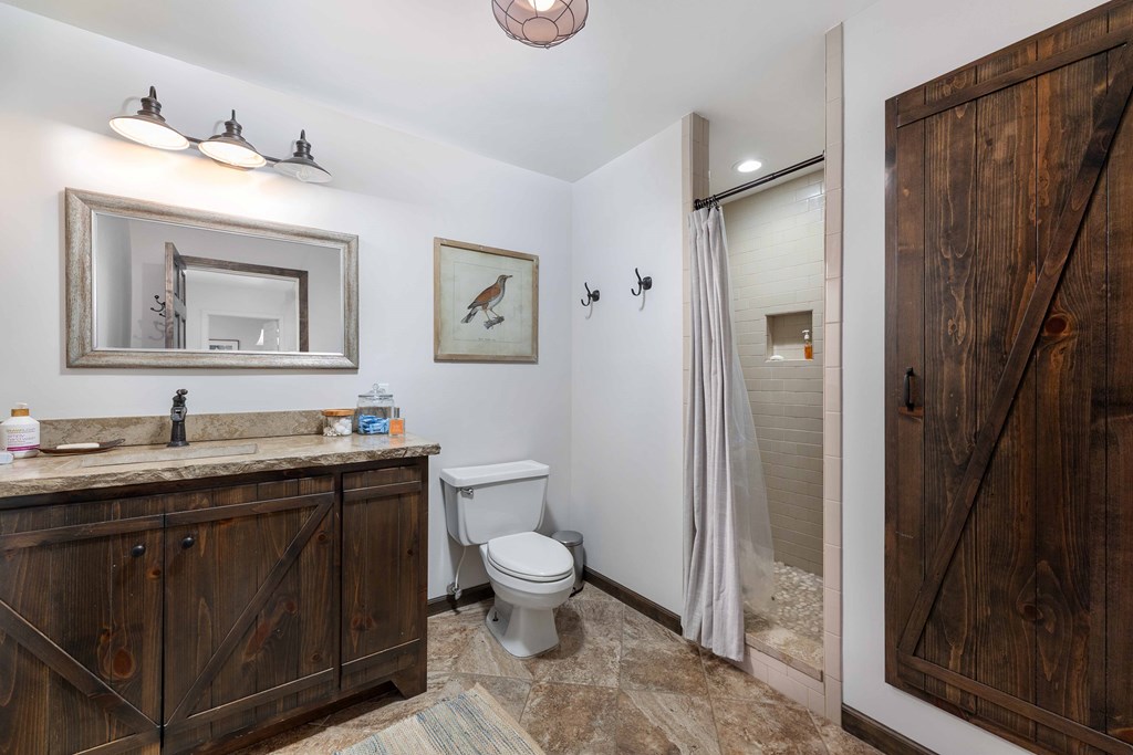 94 Hidden Trail Hamilton, GA 31811 - Photo 22 of 46 a spacious bathroom with a toilet sink and mirror