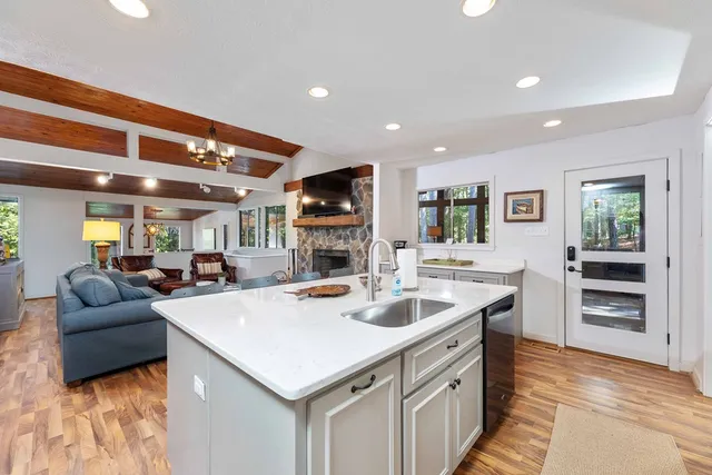 a large white kitchen with a large window