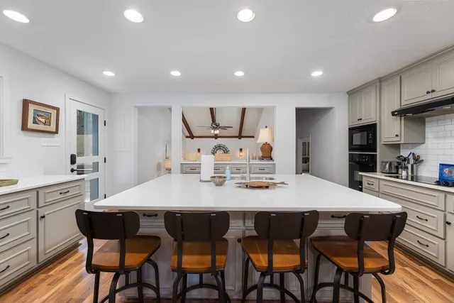 a large kitchen with dining table and chairs