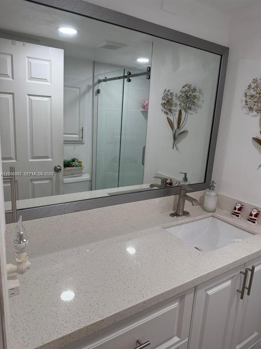 2900 North Pine Island Road, Unit 209 Sunrise, FL 33322 - Photo 13 of 14 a bathroom with a sink and a mirror