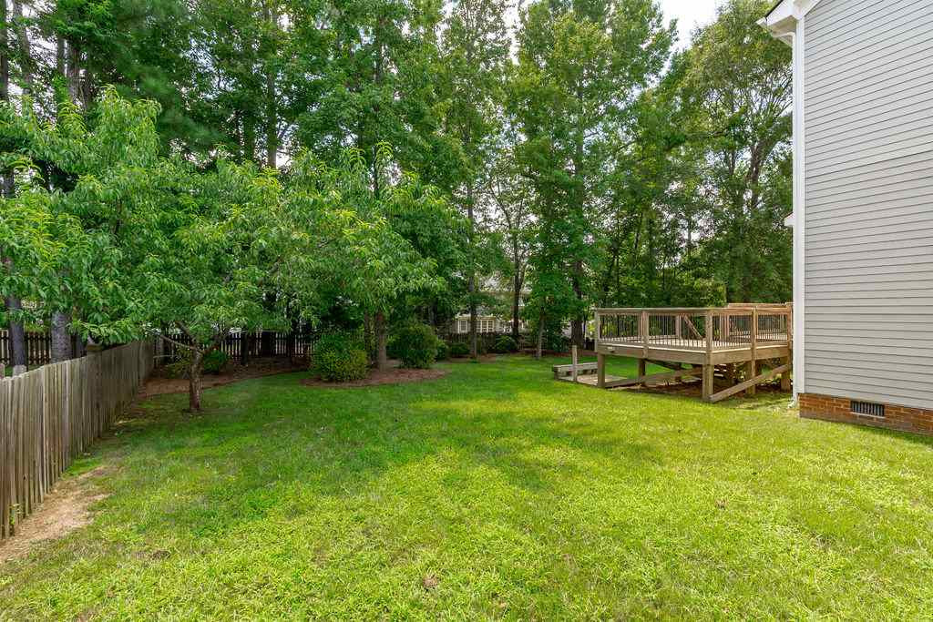 121 Redhill Road Holly Springs, NC 27540 - Photo 22 of 30 Tiered Deck Over Looks Fenced-In Yard Ideal for Entertaining Family and Friends
