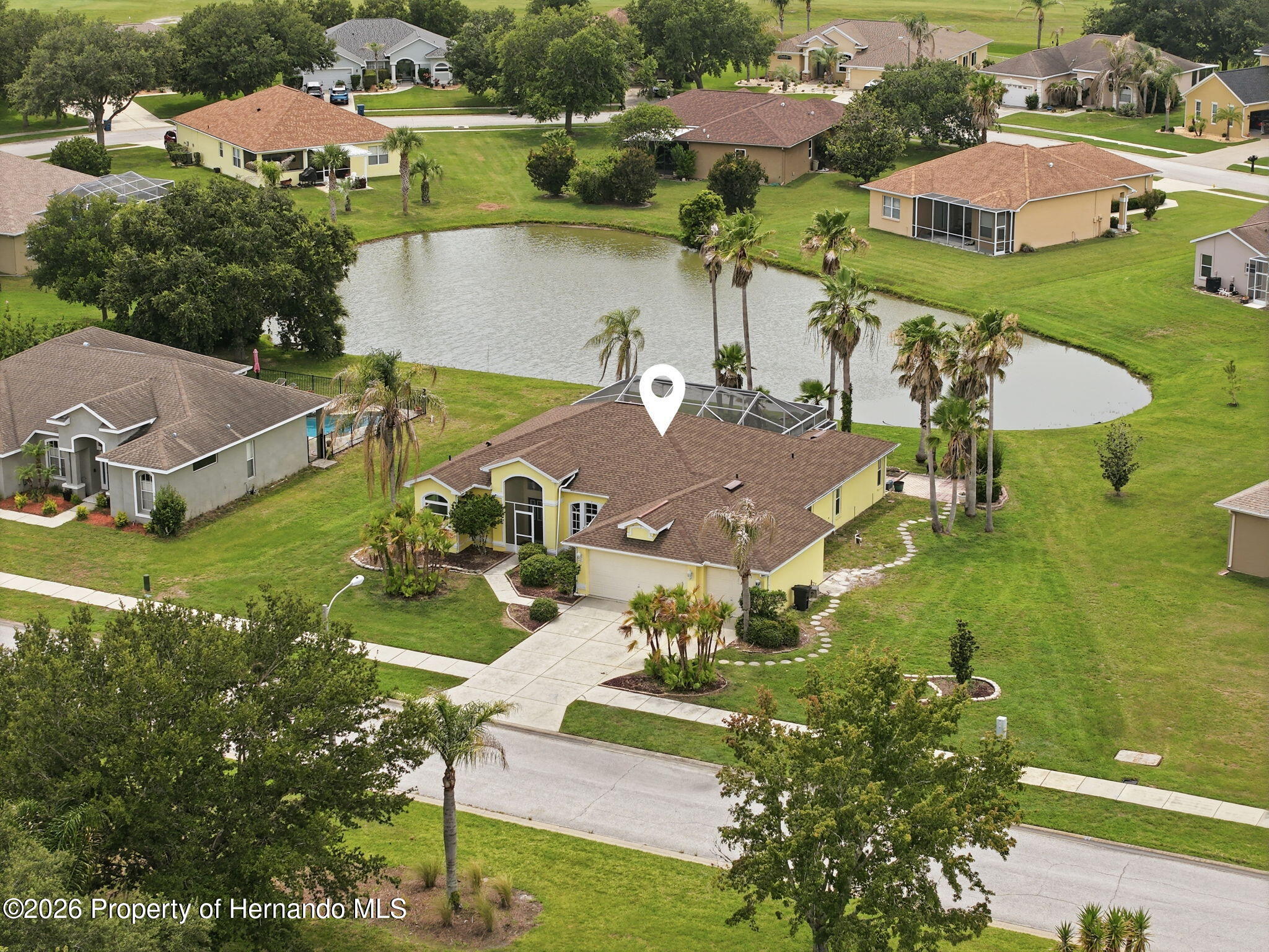18131 Rivard Boulevard Brooksville, FL 34604 - Photo 65 of 66 an aerial view of a house with a garden