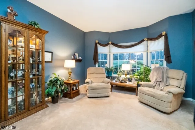 a living room with furniture and a floor to ceiling window