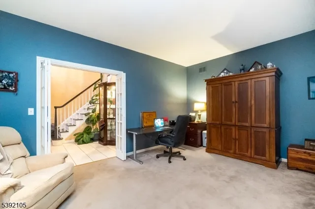 a view of a workspace with furniture and a window