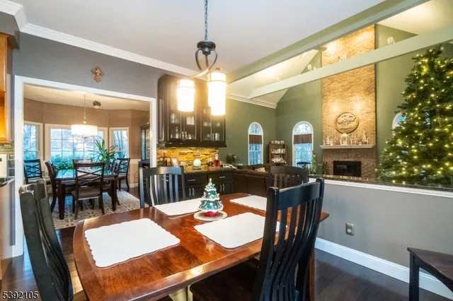 a dining room with furniture a chandelier and window