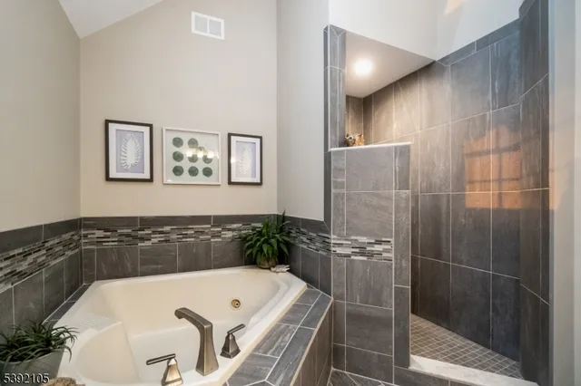 a bathroom with a tub and shower