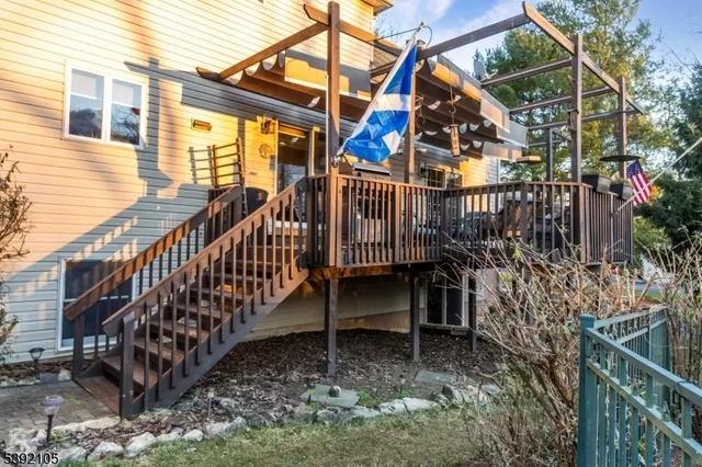 a view of wooden house with a bench in balcony